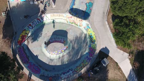 Drone-shot-vertical-top-view-over-a-skatepark-in-south-of-France.-Young-Bmx-ride